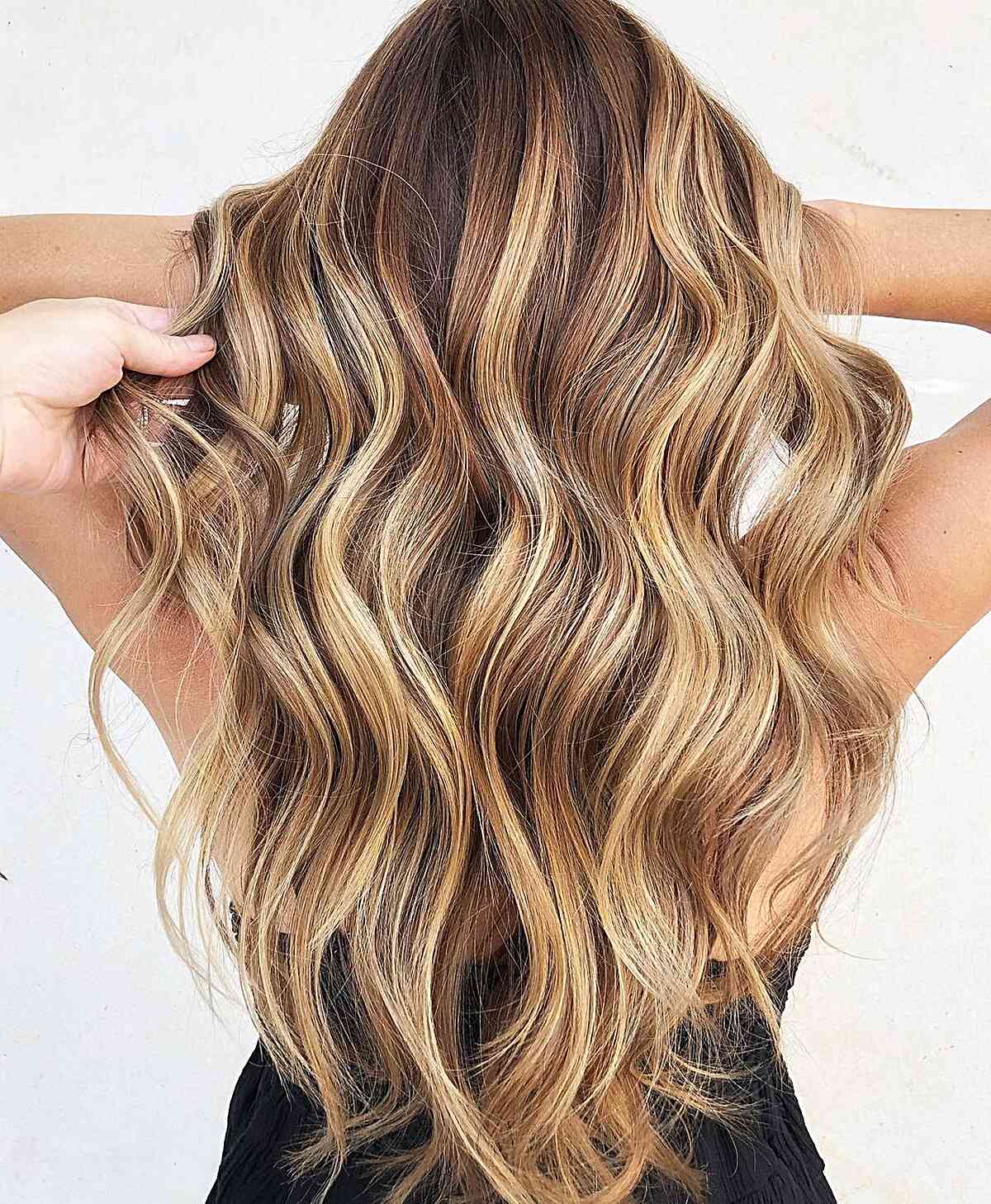 Butterscotch Bronde Hair Color for women with long wavy hair