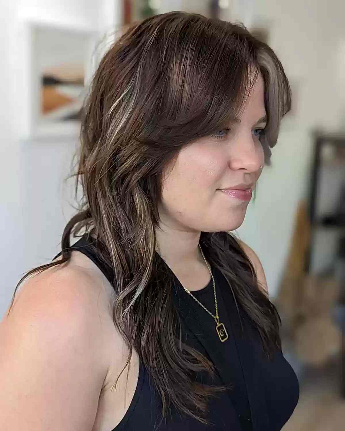 Longer Brunette Wolf Haircut with Curtain Bangs and Chunky Highlights