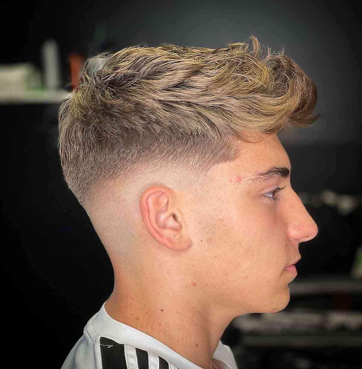 Messy Thick Curly Hair with a Mid Fade for Teens