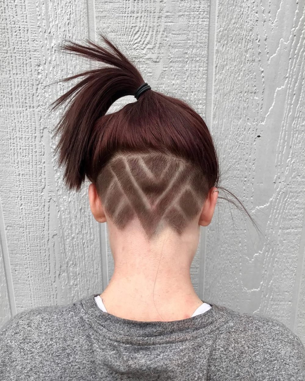 Ponytail Undercut Hairstyle with Geometric Tattoo Design